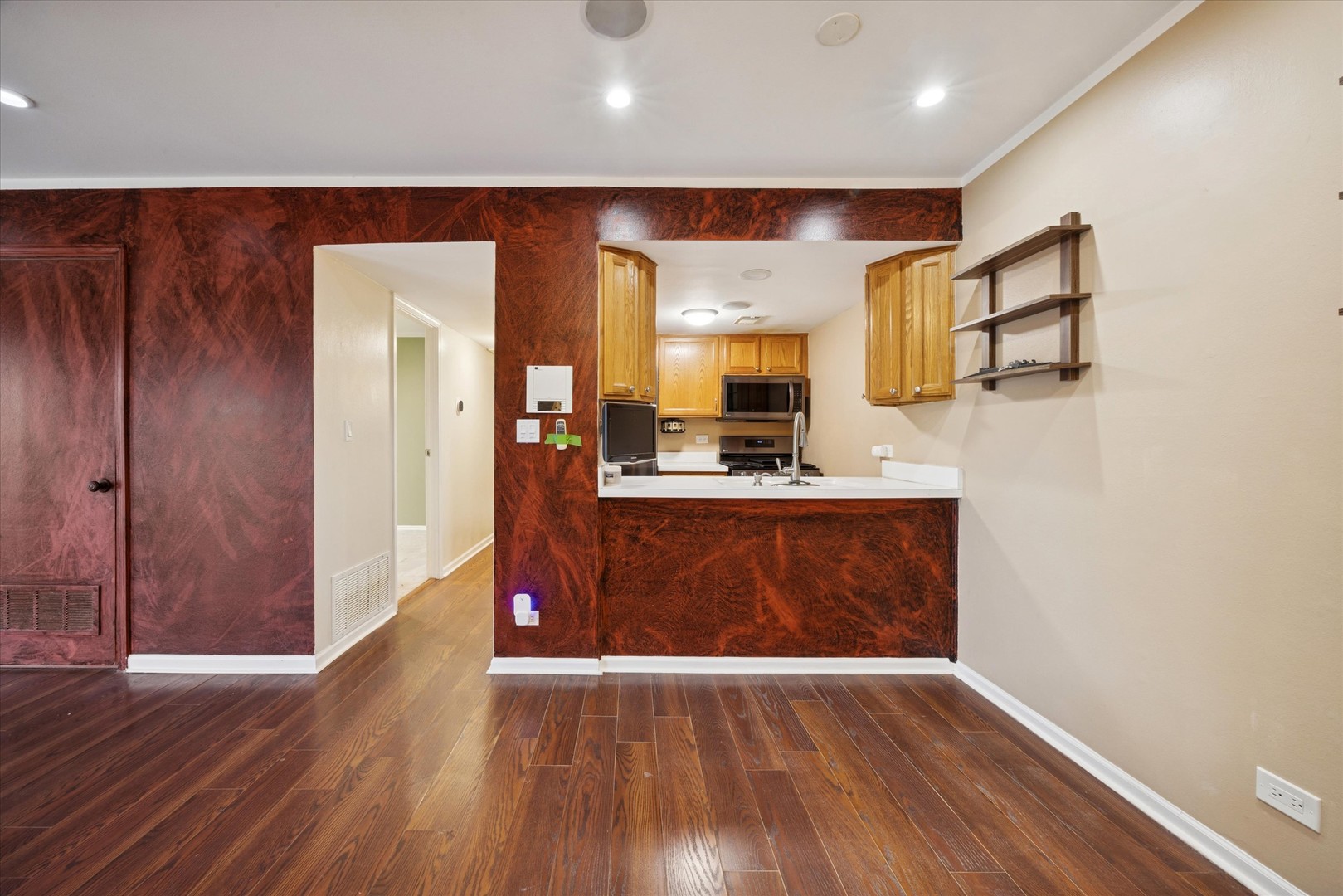 1860 Huntington Boulevard, Unit E Hoffman Estates, IL 60169 - Photo 3 of 16 a view of kitchen with cabinets and wooden floor