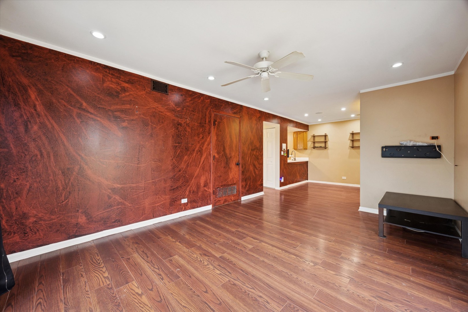 1860 Huntington Boulevard, Unit E Hoffman Estates, IL 60169 - Photo 5 of 16 a view of an empty room with wooden floor and a window