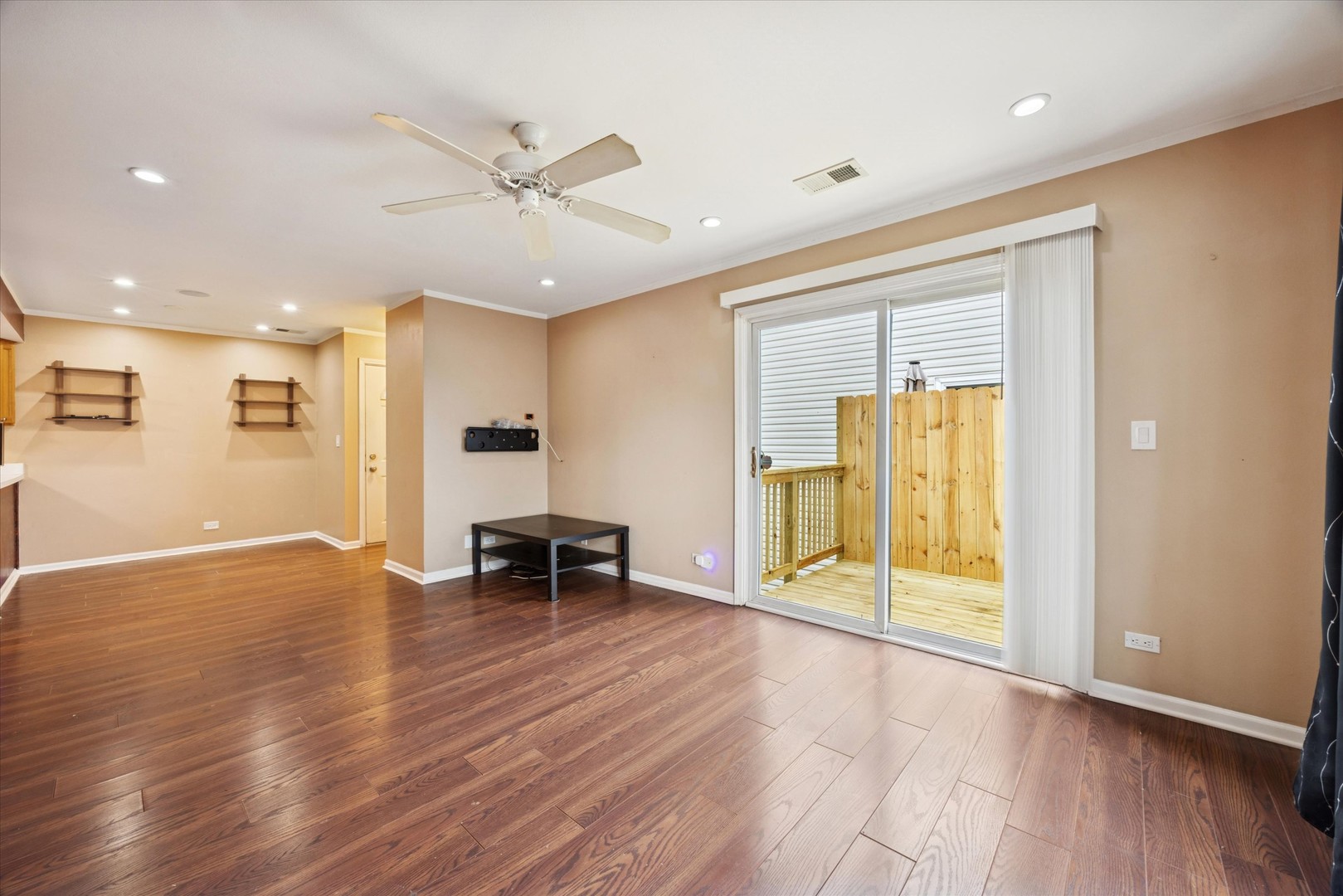 1860 Huntington Boulevard, Unit E Hoffman Estates, IL 60169 - Photo 6 of 16 a view of an empty room with wooden floor and a window