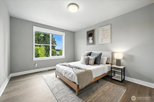 a bedroom with a large bed and a window