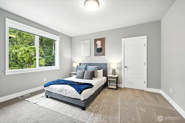 a living room with a bed furniture and a window