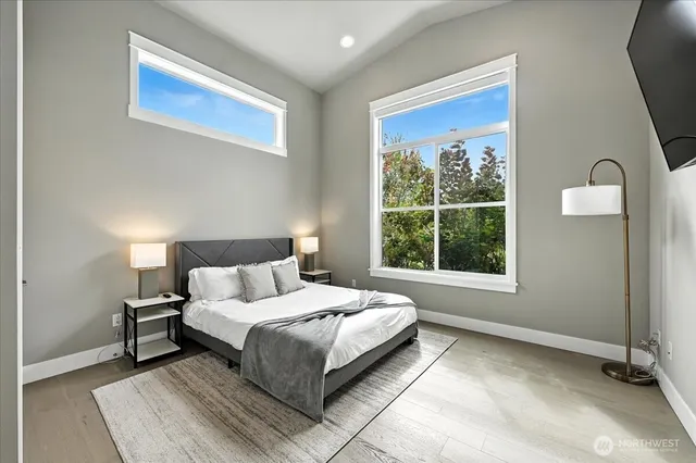 a bedroom with a bed lamp and window
