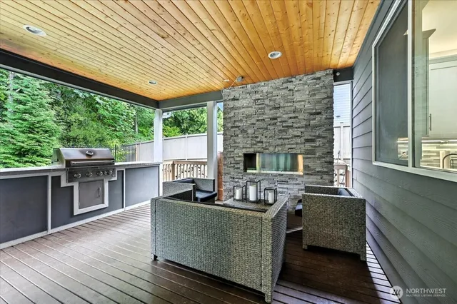a living room with furniture a fireplace and a floor to ceiling window