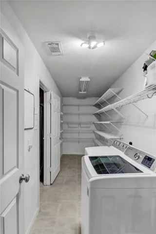 an empty room with windows and cabinet