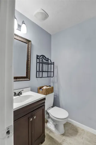 a view of an empty room with a chandelier fan