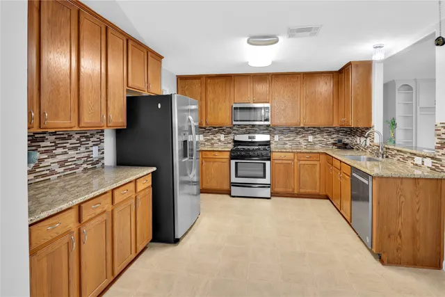 a view of an empty room with window and cabinet