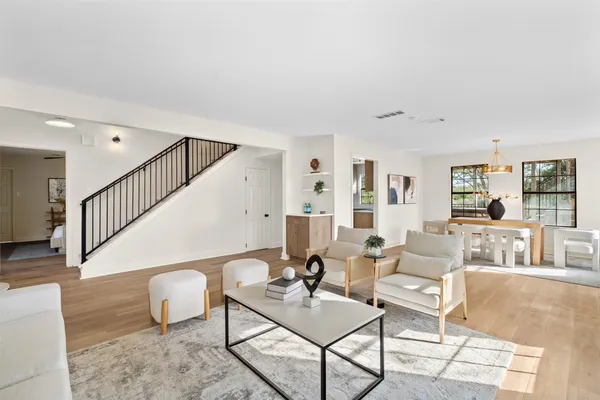 a living room with furniture and wooden floor