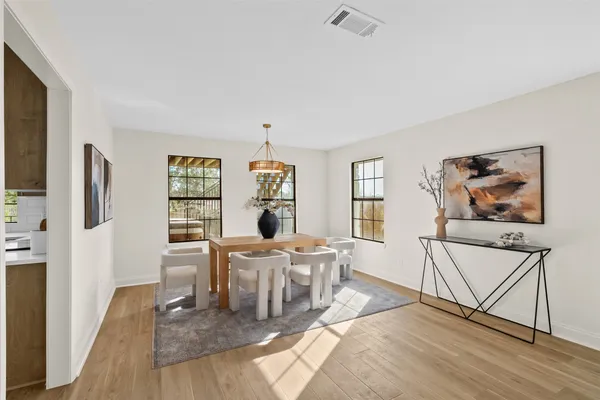 a living room with furniture a flat screen tv and a wooden floor