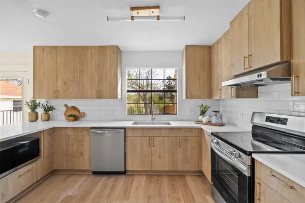 a kitchen with a sink and wooden cabinets