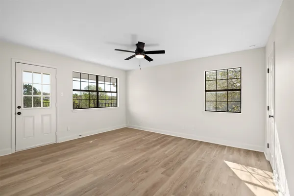 wooden floor in an empty room with a window