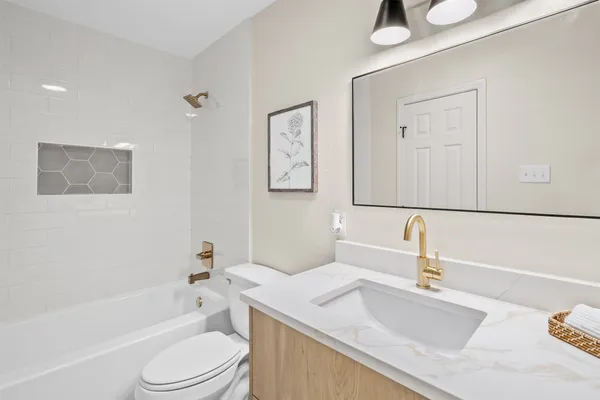 a bathroom with a sink a toilet and a bathtub