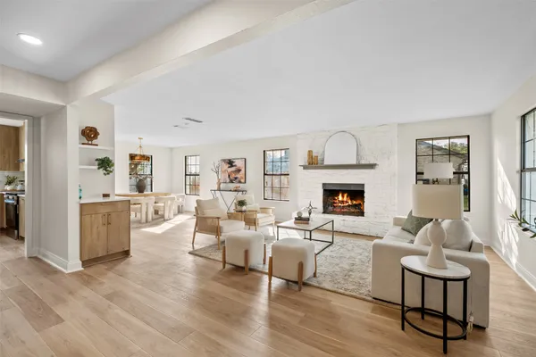 a living room with furniture fireplace and wooden floor