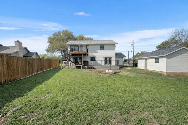a view of a house with backyard and sitting area
