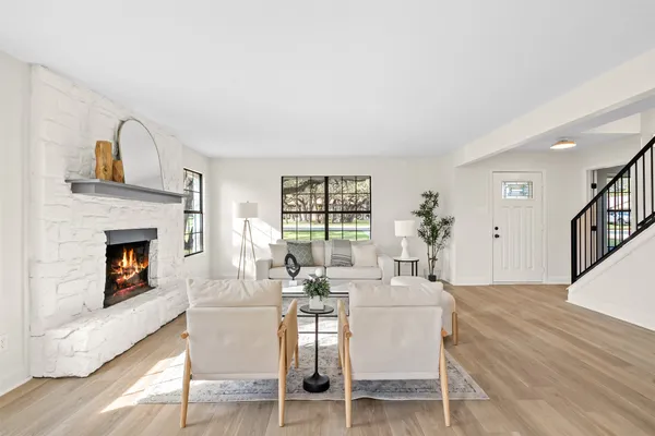 a dining room with furniture a fireplace and wooden floor