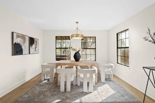 a view of a dining room with furniture and chandelier
