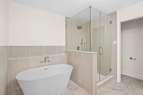 a bathroom with a tub and shower