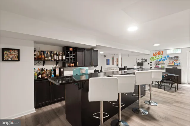 a dining room with stainless steel appliances a table and chairs