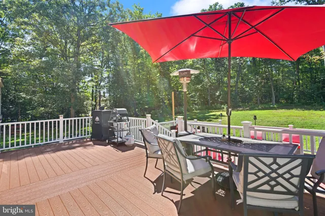 a view of an outdoor sitting area with furniture and umbrella