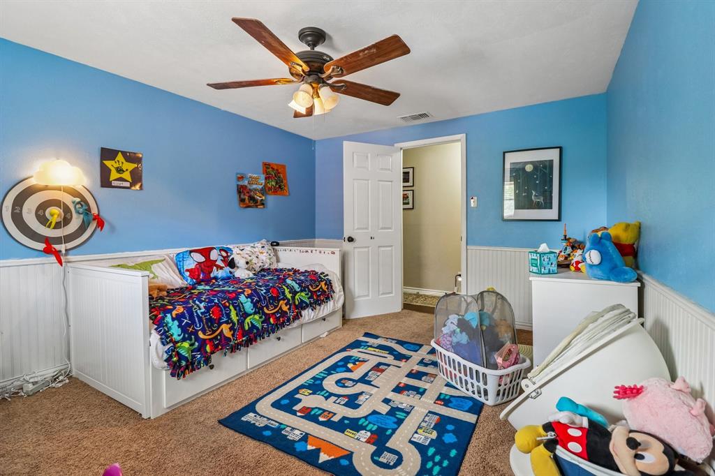 820 North Bowen Road Arlington, TX 76012 - Photo 37 of 40 a bed room with a bed a couch and a baby crib