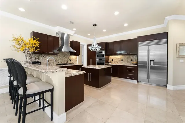 a kitchen with stainless steel appliances a sink counter space and a view of living room