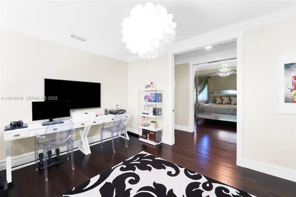 a view of a livingroom with workspace and a window