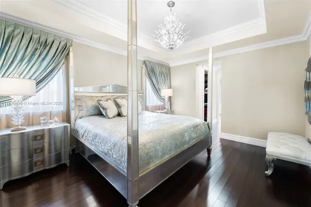a bedroom with a bed and a chandelier