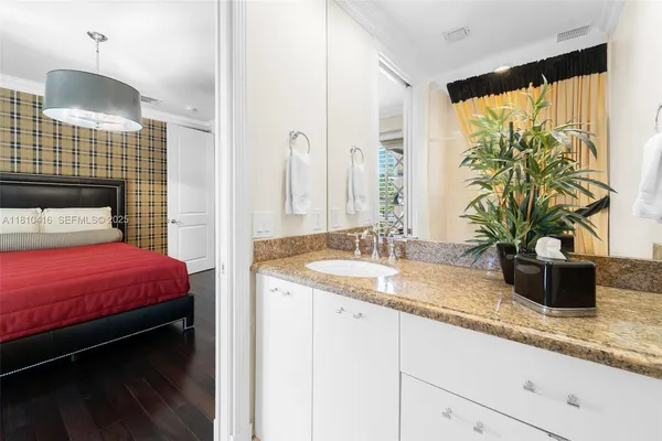 a bedroom with a bed and a potted plant