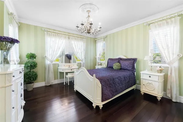 a bedroom with a bed and a chandelier