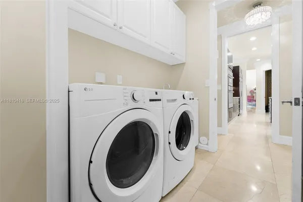 a view of a hallway with washer and dryer