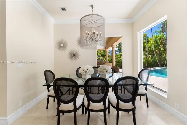 a view of a dining room with furniture and a potted plant
