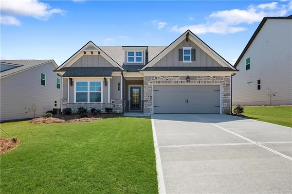 a front view of a house with a yard and garage