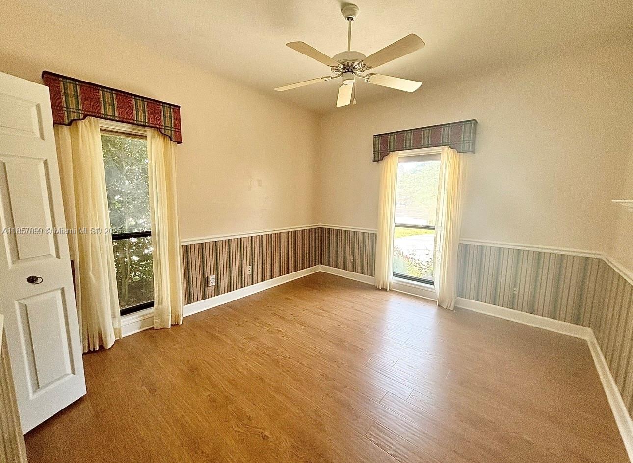 3356 North Bent Tree Point Lecanto, FL 34461 - Photo 15 of 25 an empty room with wooden floor and windows