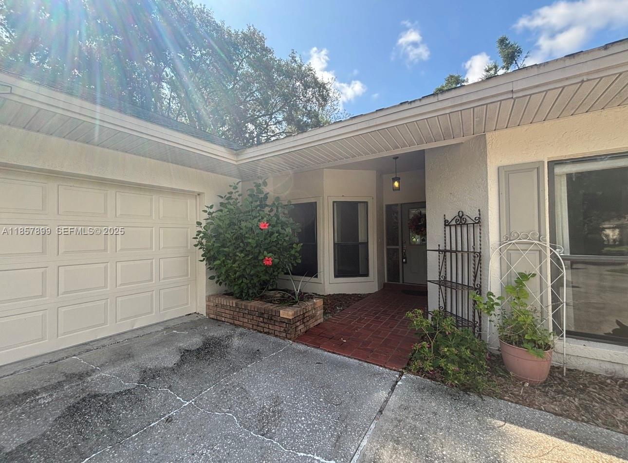 3356 North Bent Tree Point Lecanto, FL 34461 - Photo 3 of 25 a view of a house with a yard and potted plants
