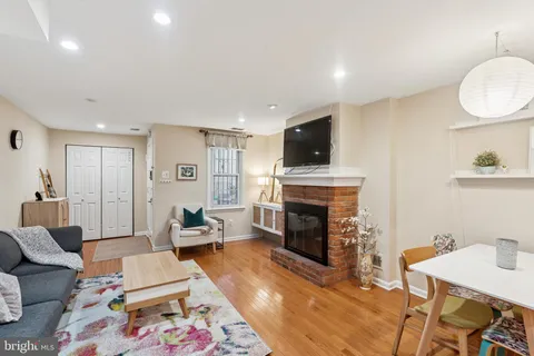 a living room with furniture a fireplace and a flat screen tv