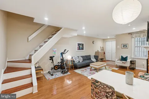 a living room with furniture and a wooden floor