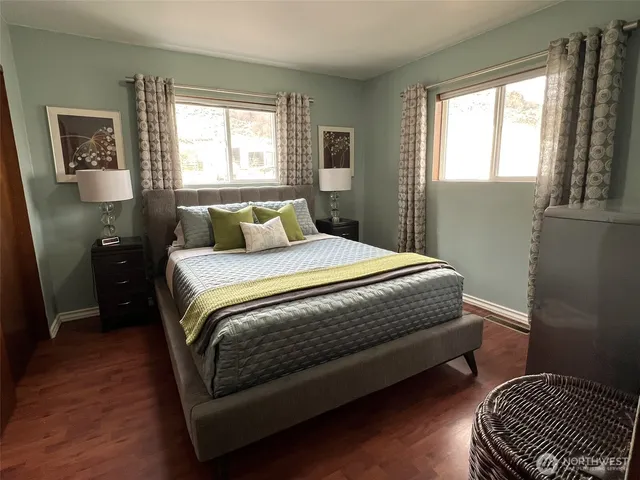 a bedroom with a bed lamp and a window