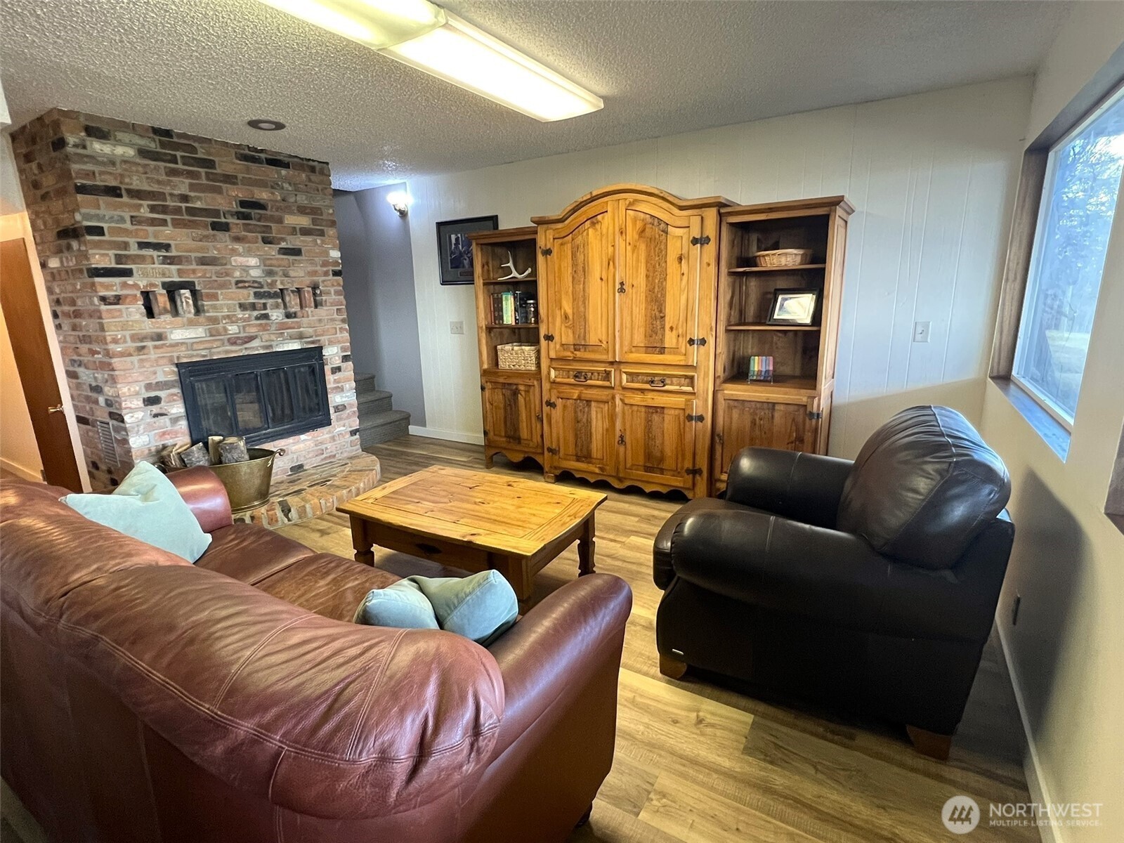 81 B Golden Road Oroville, WA 98844 - Photo 16 of 37 a living room with furniture a fireplace and a flat screen tv