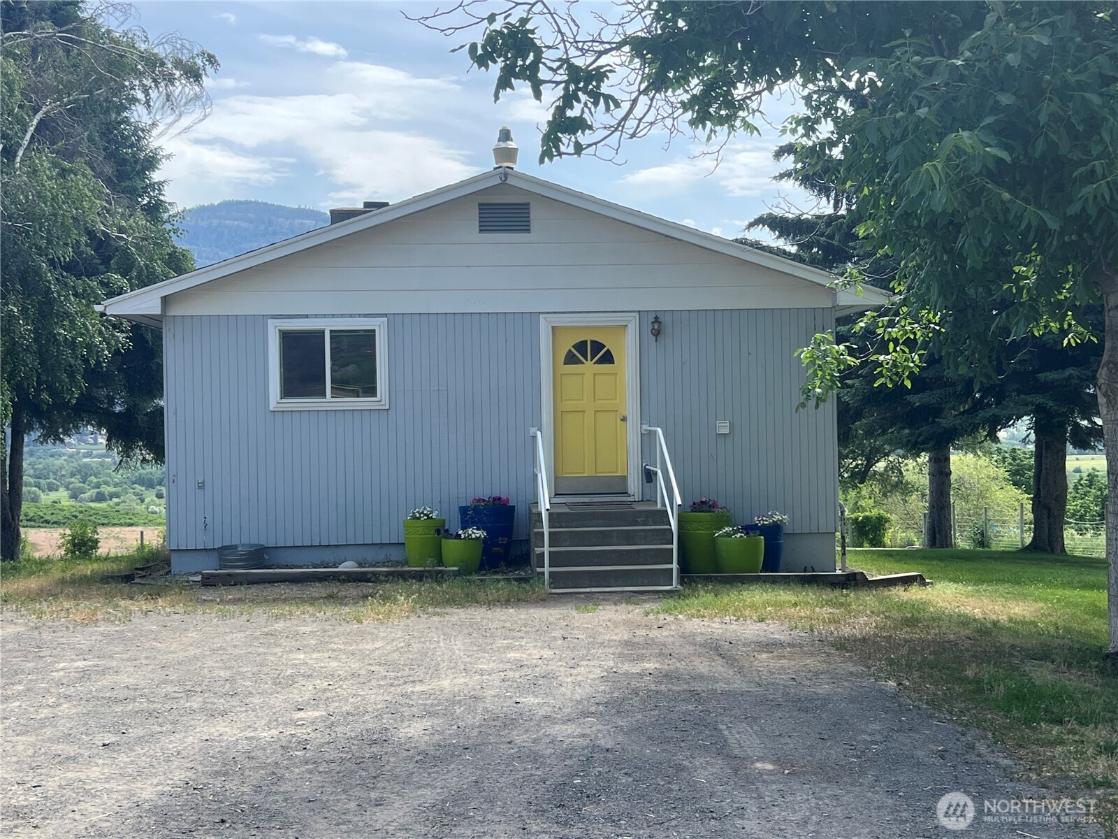 81 B Golden Road Oroville, WA 98844 - Photo 2 of 37 a front view of a house with a yard