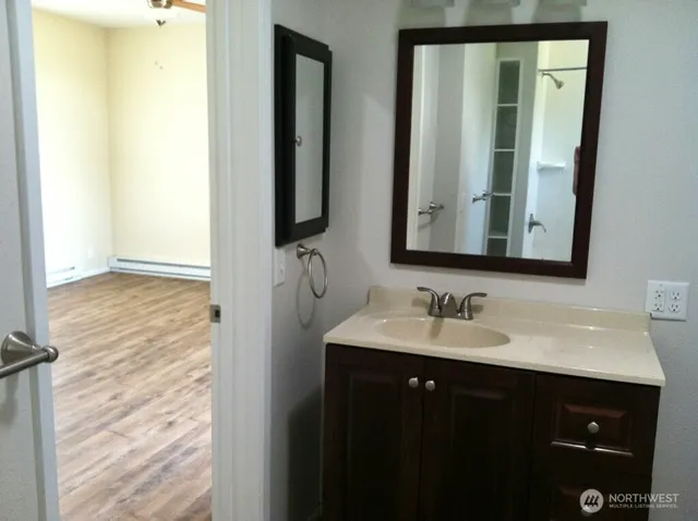 a bathroom with a double vanity sink and a mirror