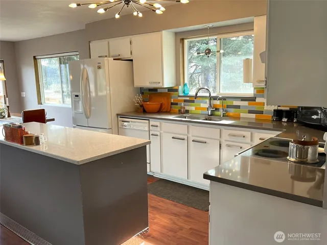 a kitchen with stainless steel appliances a sink stove and refrigerator