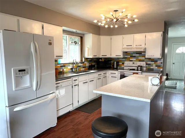 a kitchen with stainless steel appliances a refrigerator sink and cabinets