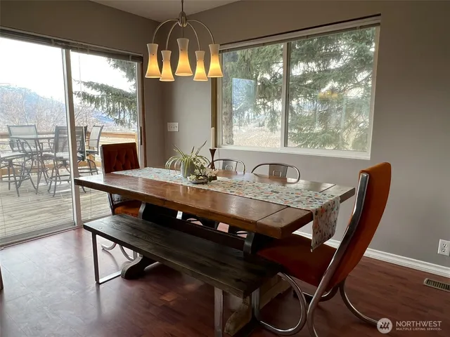 a view of a dining room with furniture window and wooden floor