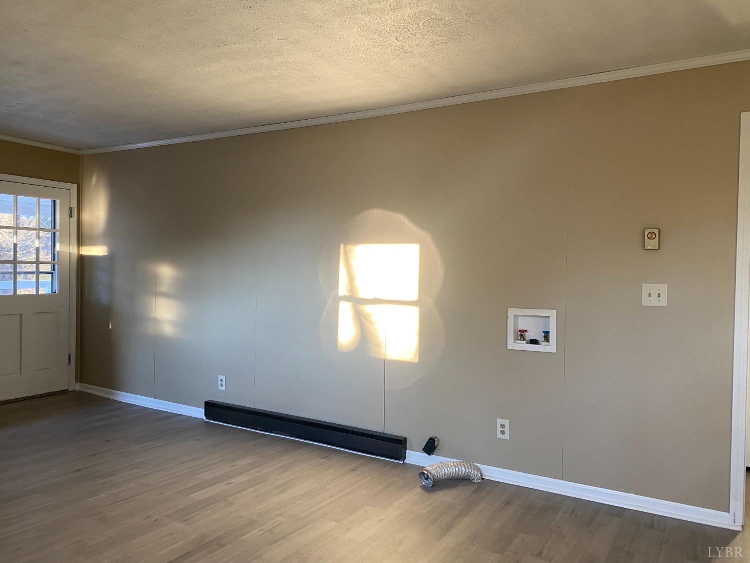 5936 Riceville Road Gretna, VA 24557 - Photo 7 of 19 an empty room with wooden floor and windows