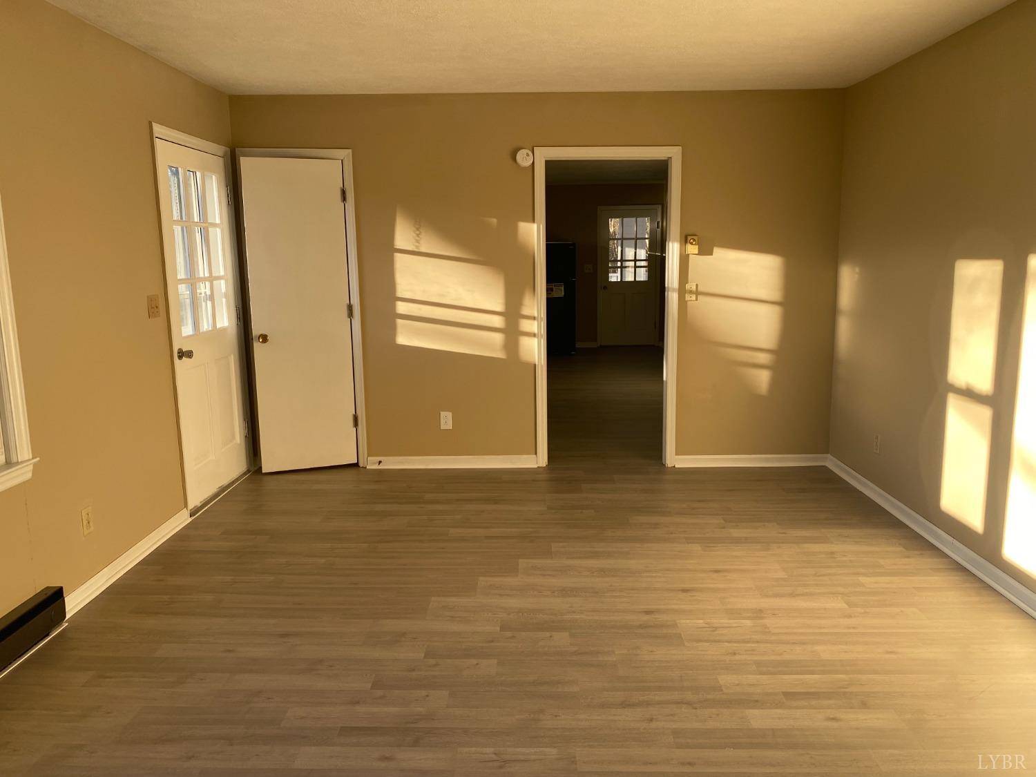 5936 Riceville Road Gretna, VA 24557 - Photo 10 of 19 a view of an empty room with kitchen and window