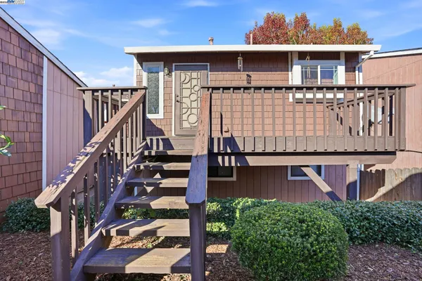 a front view of a house with wooden stairs
