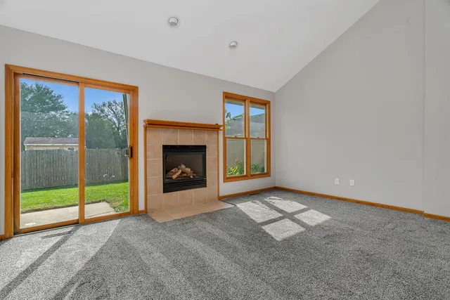 a view of an empty room with window and an empty room