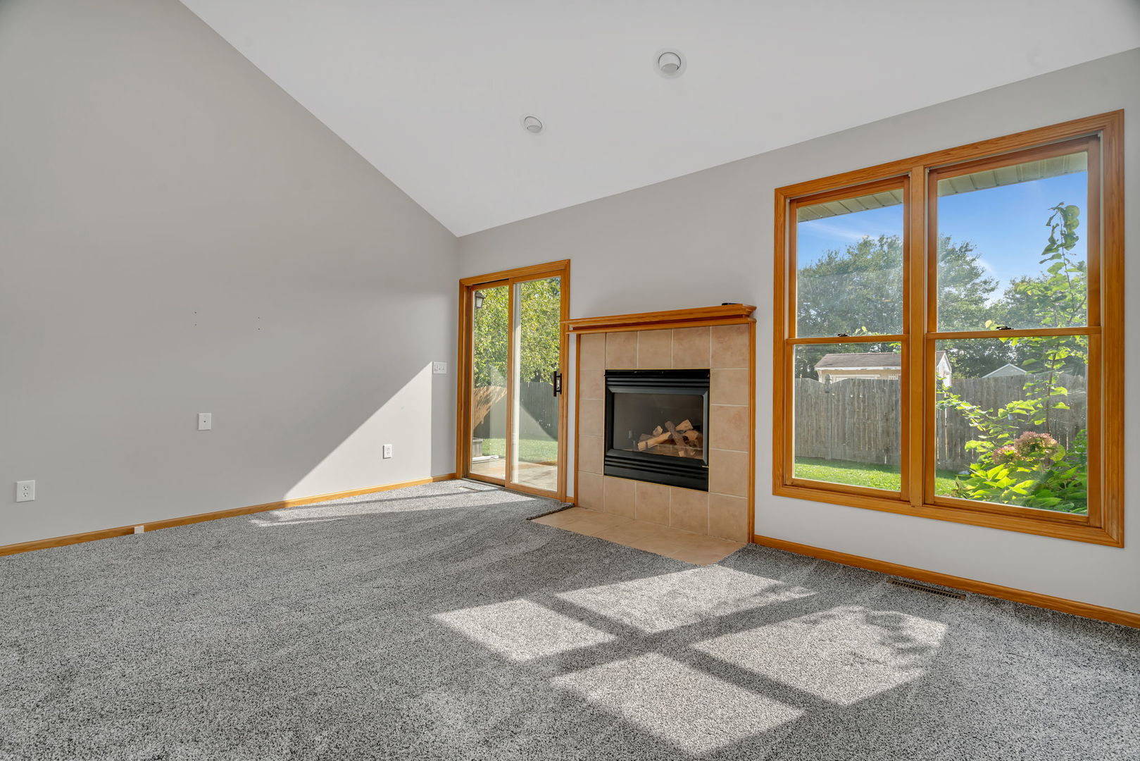 210 Kevin Drive Diamond, IL 60416 - Photo 13 of 23 a view of an empty room with a window and a fireplace