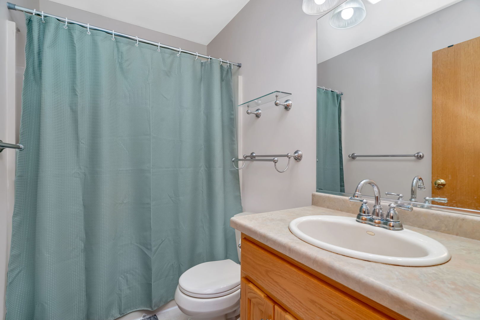 210 Kevin Drive Diamond, IL 60416 - Photo 18 of 23 a bathroom with a sink a toilet and shower curtain
