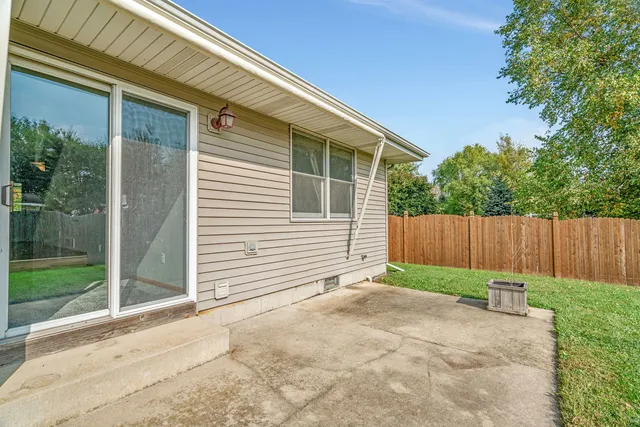 a view of backyard with small cabin and wooden fence
