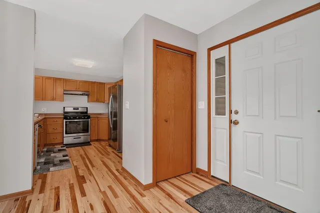 a kitchen with wooden floor and a refrigerator